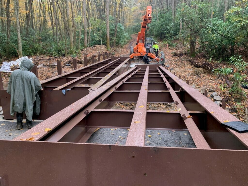 Crane loads metal trusses into place