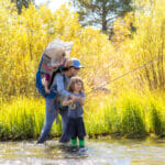 Woman helps daughter fish