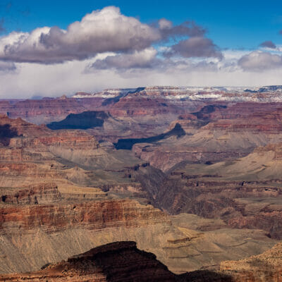 The Grand Canyon with snow at the rim and low hanging clouds
